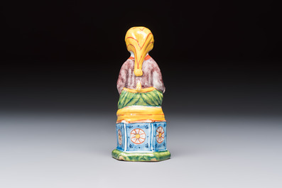 A polychrome Dutch Delft model of a seated oriental figure, 18th C.