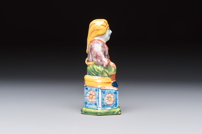 A polychrome Dutch Delft model of a seated oriental figure, 18th C.