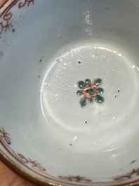 A Chinese famille verte teapot and three famille rose capucine-ground cups and saucers, Kangxi/Qianlong