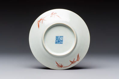 Four Chinese famille rose saucers and a gilt-decorated powder-blue-ground saucer, Qianlong and Jiaqing marks, 18/19th C.