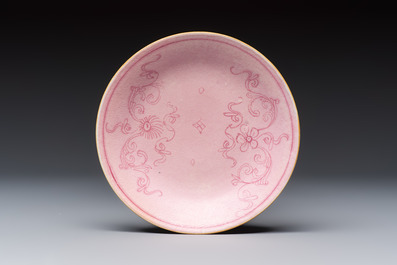 Four Chinese famille rose saucers and a gilt-decorated powder-blue-ground saucer, Qianlong and Jiaqing marks, 18/19th C.