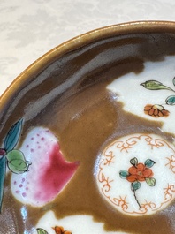 A Chinese famille verte teapot and three famille rose capucine-ground cups and saucers, Kangxi/Qianlong