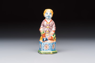 A polychrome Dutch Delft model of a seated oriental figure, 18th C.