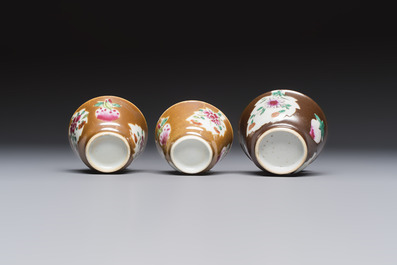 A Chinese famille verte teapot and three famille rose capucine-ground cups and saucers, Kangxi/Qianlong