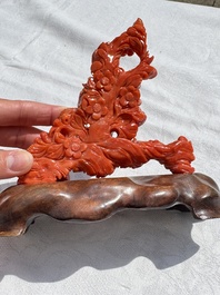 A Chinese carved red coral 'Birds and Flowers' group on a wooden stand, 19/20th C.