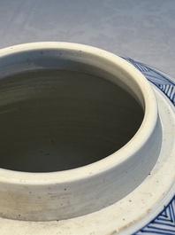 A Chinese blue and white 'Antiquities and Flower Baskets' vase with a wooden cover, Kangxi