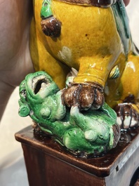 A pair of Chinese sancai-glazed Buddhist lions, Kangxi mark, 19th C.