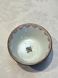 A Chinese famille verte teapot and three famille rose capucine-ground cups and saucers, Kangxi/Qianlong