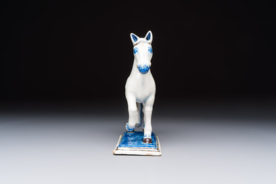 A polychrome Dutch Delft model of a standing horse with a figurative saddle cloth, 18th C.