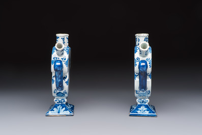 A pair of blue and white Dutch Delft tulip vases with a lady holding a cornucopia, 19th C.