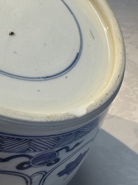 A Chinese blue and white 'Antiquities and Flower Baskets' vase with a wooden cover, Kangxi