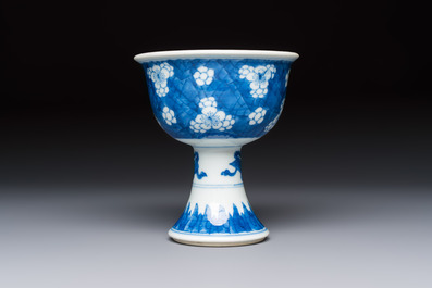 A Chinese blue and white 'Prunus on Cracked Ice' stem bowl, Kangxi