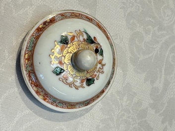 A Chinese famille verte teapot and three famille rose capucine-ground cups and saucers, Kangxi/Qianlong
