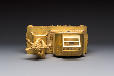 A French fire-gilt mantel clock with a music making cherub, early 19th C.
