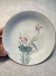 Four Chinese famille rose saucers and a gilt-decorated powder-blue-ground saucer, Qianlong and Jiaqing marks, 18/19th C.