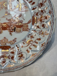 A pair of Chinese gilt iron-red-decorated 'Falconry' plates, Kangxi