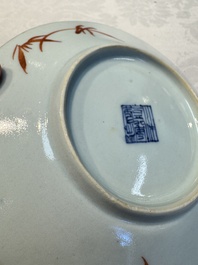 Four Chinese famille rose saucers and a gilt-decorated powder-blue-ground saucer, Qianlong and Jiaqing marks, 18/19th C.