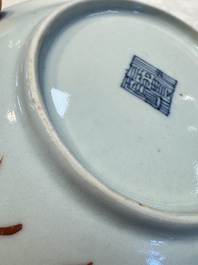 Four Chinese famille rose saucers and a gilt-decorated powder-blue-ground saucer, Qianlong and Jiaqing marks, 18/19th C.