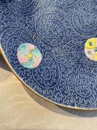 Four Chinese famille rose saucers and a gilt-decorated powder-blue-ground saucer, Qianlong and Jiaqing marks, 18/19th C.