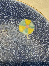 Four Chinese famille rose saucers and a gilt-decorated powder-blue-ground saucer, Qianlong and Jiaqing marks, 18/19th C.