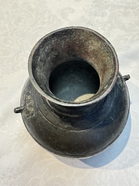 A miniature Chinese archaic bronze wine vessel with Taotie handles, 'Hu 壺', Han