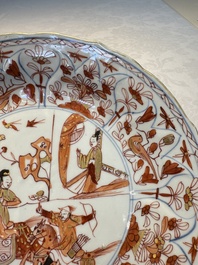 A pair of Chinese gilt iron-red-decorated 'Falconry' plates, Kangxi