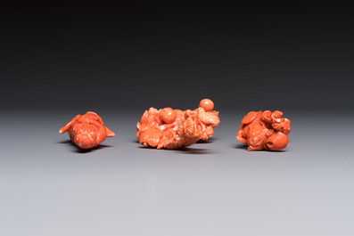 Three Chinese red coral carvings on wooden stands, 19/20th C.