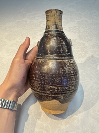 Three khmer-style brown-glazed anthropomorphic gourd-form bottles, probably 12/13th C.