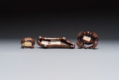 Three Chinese red coral carvings on wooden stands, 19/20th C.