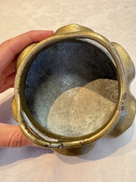 A Chinese bronze flower-shaped tripod censer with handles, Xuande mark, 19th C.
