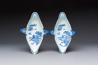 A pair of Chinese blue and white handled sauce boats and stands with pagodas along a river, Qianlong