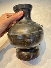 A miniature Chinese archaic bronze wine vessel with Taotie handles, 'Hu 壺', Han