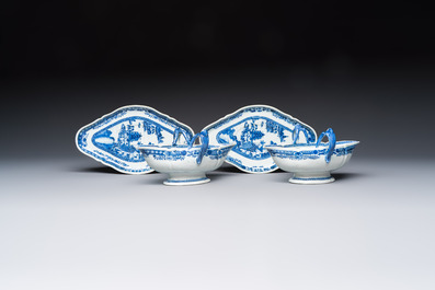 A pair of Chinese blue and white handled sauce boats and stands with pagodas along a river, Qianlong