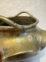 A Chinese bronze flower-shaped tripod censer with handles, Xuande mark, 19th C.