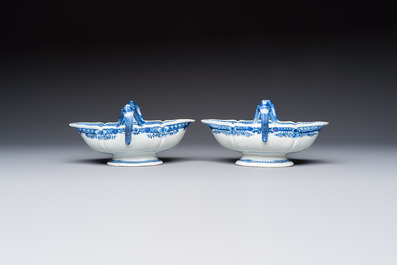 A pair of Chinese blue and white handled sauce boats and stands with pagodas along a river, Qianlong