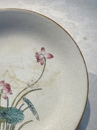 Four Chinese famille rose saucers and a gilt-decorated powder-blue-ground saucer, Qianlong and Jiaqing marks, 18/19th C.