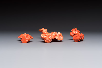Three Chinese red coral carvings on wooden stands, 19/20th C.