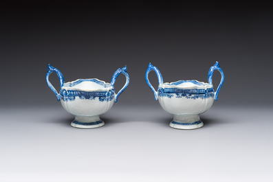 A pair of Chinese blue and white handled sauce boats and stands with pagodas along a river, Qianlong