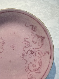 Four Chinese famille rose saucers and a gilt-decorated powder-blue-ground saucer, Qianlong and Jiaqing marks, 18/19th C.