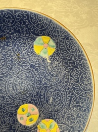 Four Chinese famille rose saucers and a gilt-decorated powder-blue-ground saucer, Qianlong and Jiaqing marks, 18/19th C.