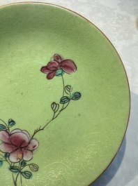 Four Chinese famille rose saucers and a gilt-decorated powder-blue-ground saucer, Qianlong and Jiaqing marks, 18/19th C.
