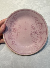 Four Chinese famille rose saucers and a gilt-decorated powder-blue-ground saucer, Qianlong and Jiaqing marks, 18/19th C.