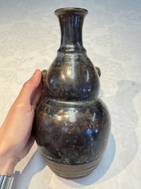 Three khmer-style brown-glazed anthropomorphic gourd-form bottles, probably 12/13th C.