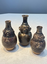 Three khmer-style brown-glazed anthropomorphic gourd-form bottles, probably 12/13th C.