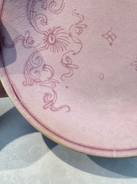 Four Chinese famille rose saucers and a gilt-decorated powder-blue-ground saucer, Qianlong and Jiaqing marks, 18/19th C.