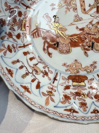 A pair of Chinese gilt iron-red-decorated 'Falconry' plates, Kangxi
