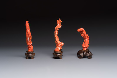 Three Chinese red coral carvings on wooden stands, 19/20th C.