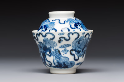 A Chinese blue and white 'Buddhist Lion' teapot, covered bowl and a saucer, various marks, 19th C.