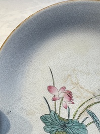 Four Chinese famille rose saucers and a gilt-decorated powder-blue-ground saucer, Qianlong and Jiaqing marks, 18/19th C.