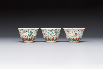 Seven Chinese famille verte cups and four saucers, conch shell and lingzhi marks, Kangxi